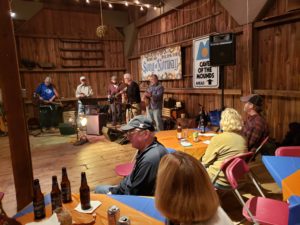 People enjoying beverages in rustic Wisconsin barn