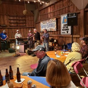 People enjoying beverages in rustic Wisconsin barn